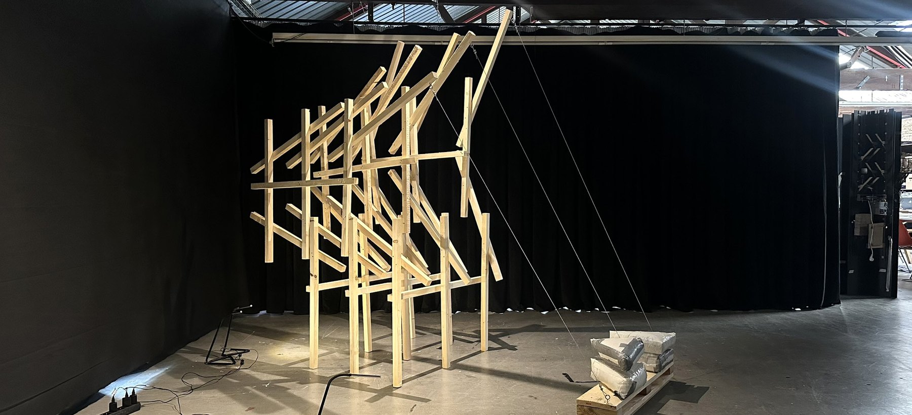 Segmented timber shell prototype in a workshop setting.