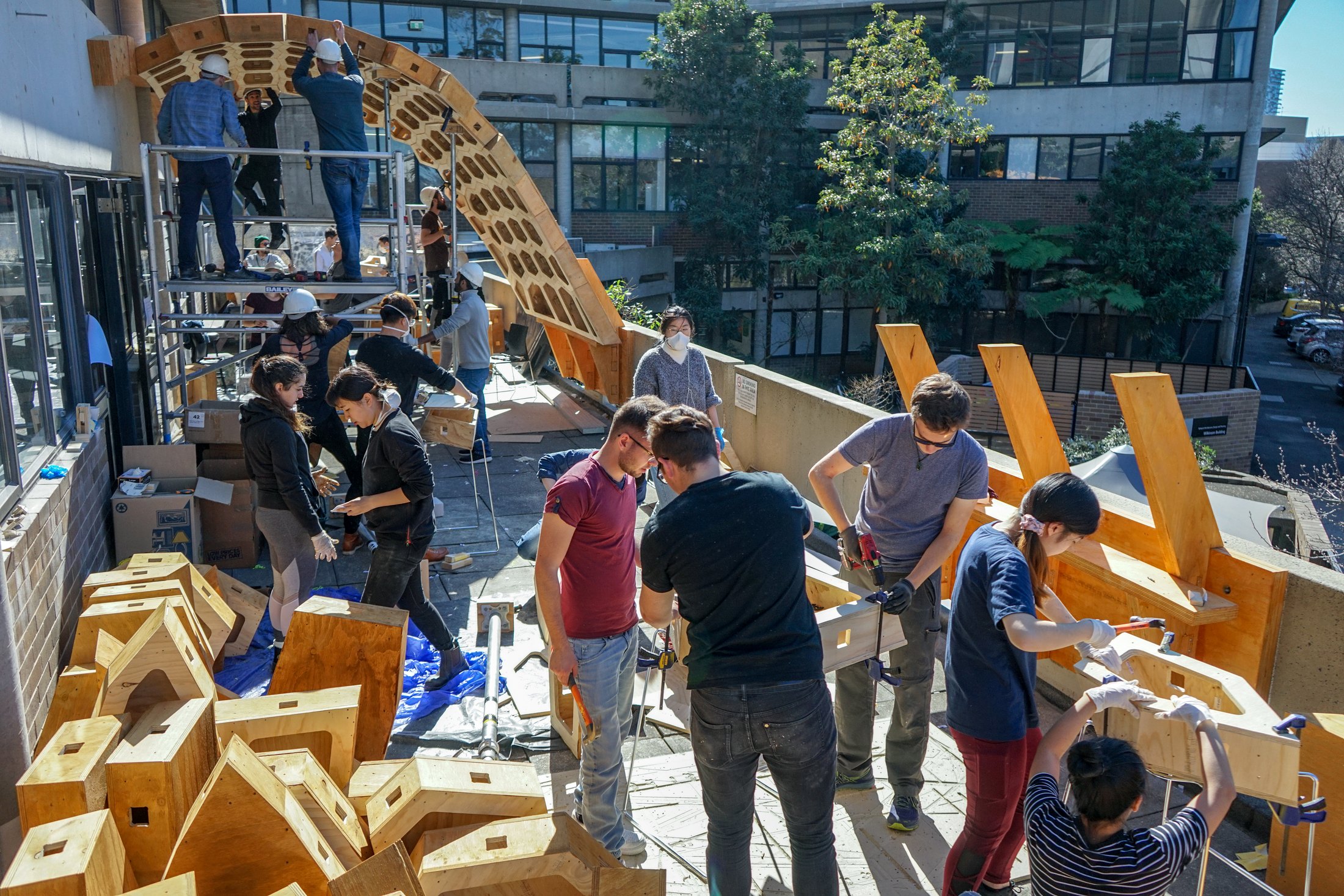 Team assembling timber box modules on site.
